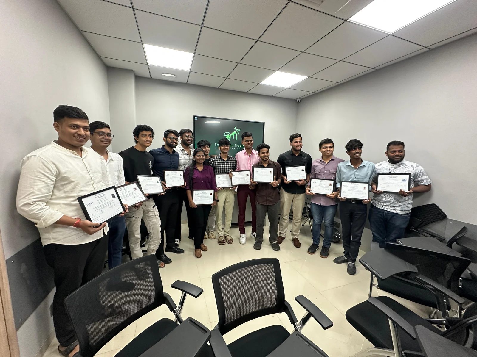 An SMT batch holding their NISM certificates in the Girgaon classroom